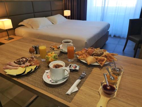 a tray of breakfast foods on a table in a hotel room at Hotel Residence Lido Marana in Furiani