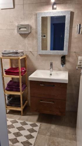 a bathroom with a sink and a mirror at Villa Weisse Düne in Göhren