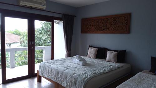 Ένα ή περισσότερα κρεβάτια σε δωμάτιο στο Fueangfu Home Hostel