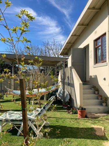 a house with a yard with a tree at Waves Of Witsand in Witsand
