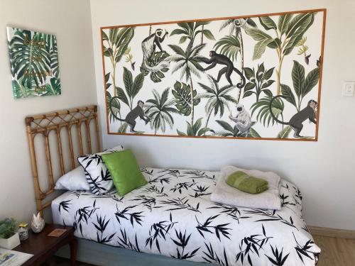 a bedroom with a bed and a painting on the wall at Waves Of Witsand in Witsand