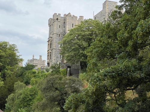 an old castle with trees in front of it at Urban Living's - Windsor Castle Luxury Apartments in Windsor