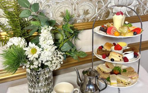 two plates of food sitting on a table with flowers at The Bulkeley Hotel in Beaumaris