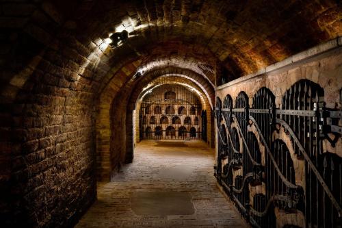 a dark hallway with a tunnel with graffiti on the wall at Villa Daniela in Úvaly