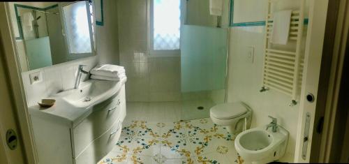 a white bathroom with a sink and a toilet at Tenuta Amalthea in Sessa Aurunca