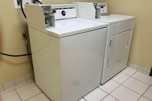 a white washer and dryer in a room at AmericInn by Wyndham, Galesburg, IL in Galesburg