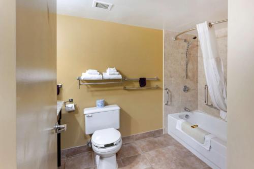 a bathroom with a toilet and a tub and a shower at Best Western Plus Mariposa Inn & Conference Centre in Orillia