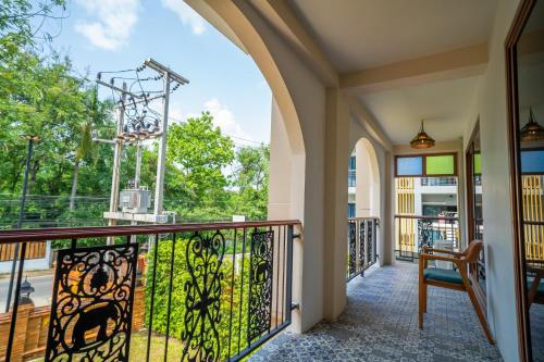 a balcony with a gate with a view at Siri Nakornpink Chiang Mai Hotel SHA Plus in Chiang Mai
