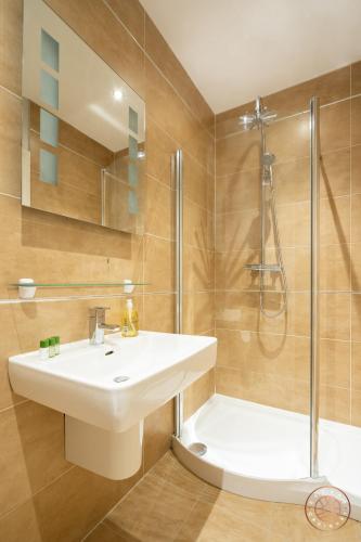 a bathroom with a sink and a shower at Escape Ordinary at Castle Hume in Enniskillen
