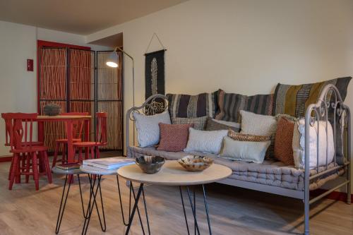 a living room with a couch and two tables at Casa Lidador - Obidos in Óbidos