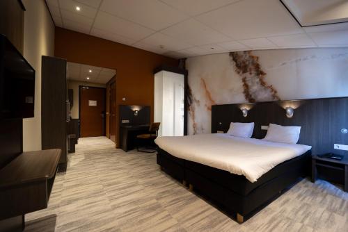 Fletcher Wellness-Hotel Brabant-Mill tesisinde bir odada yatak veya yataklar
