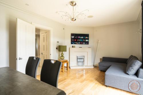 a living room with a couch and a table at Escape Ordinary at Castle Hume in Enniskillen