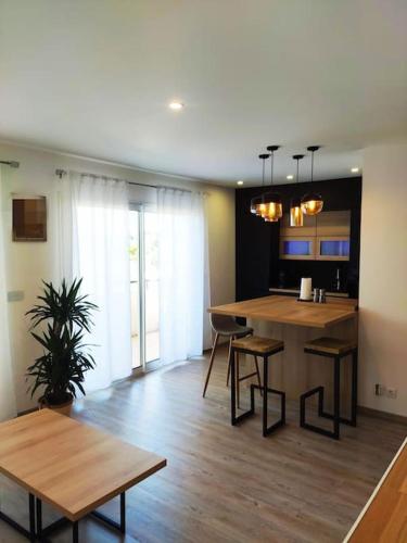 a kitchen and living room with a table and chairs at Harmonie du sud in Le Grau-dʼAgde