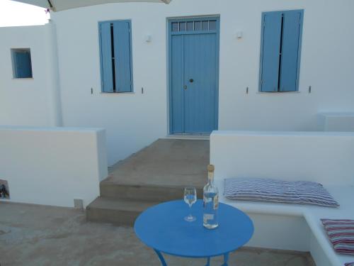 a blue table with two wine glasses on it at Kalliope summer house in Tripití