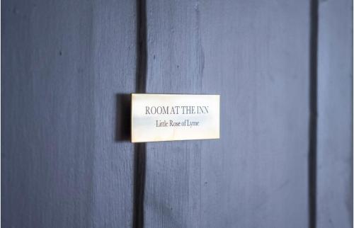 a sign on a wall that says room hit their way at Room at the Inn in Lyme Regis