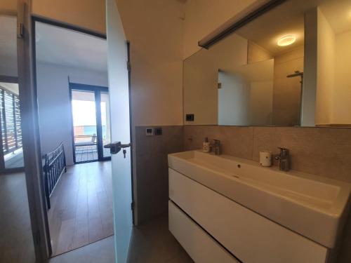 a bathroom with a sink and a large mirror at House G in Supetar
