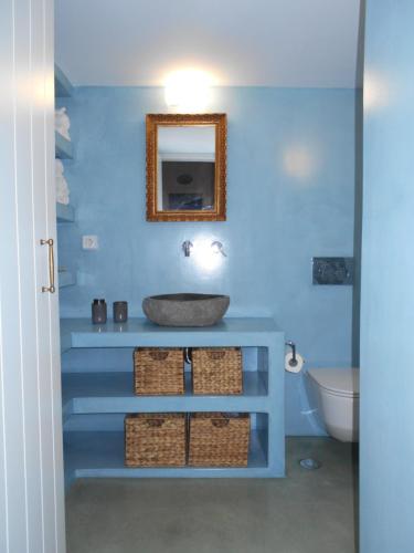 a blue bathroom with a sink and a mirror at Kalliope sea view summer house in Tripití