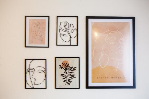 a group of four framed drawings on a wall at Zaži Apartmány Mýto pod Ďumbierom in Mýto pod Ďumbierom