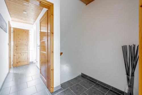 a hallway with a door and a vase on the floor at Private Room in Hannover