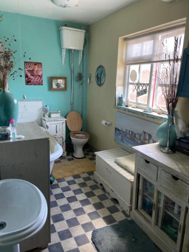 a bathroom with a sink and a toilet and a window at Comfy Cosy Room Tv fridge microwave in Upton