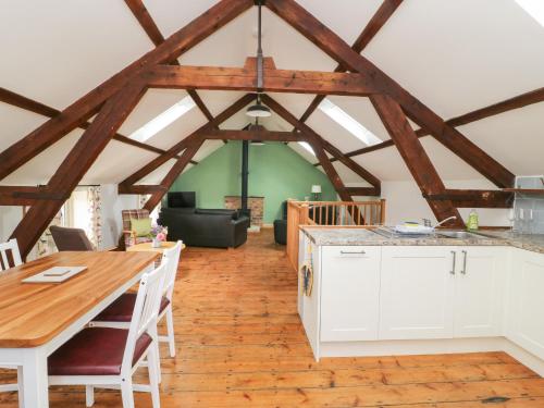 a kitchen with a table and a dining room at Joiners Cottage in York