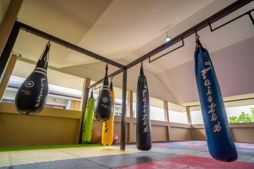 a group of surfboards hanging from a rack in a room at Siri Nakornpink Chiang Mai Hotel SHA Plus in Chiang Mai