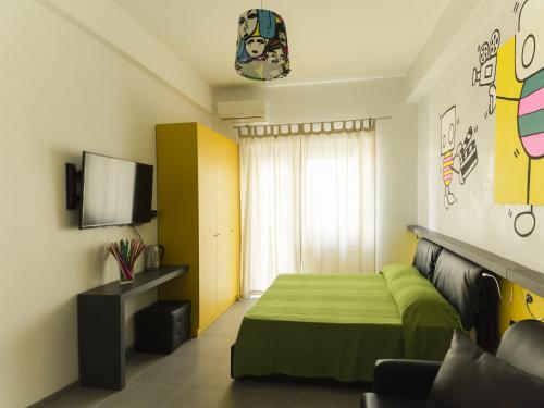 a bedroom with a green bed and a television at Affittacamere Tiburstation 2 in Rome