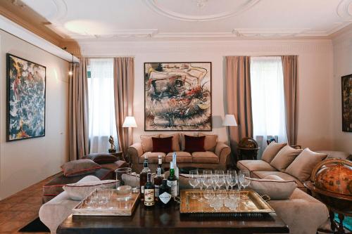 a living room with a couch and a table with wine glasses at Ada Home in Rome