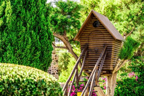 a wooden bird house with a giraffe in the background at Nectar luxury apartments in Sitia