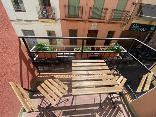 a group of wooden chairs sitting on a balcony at Cozy Apartment in Centre of Alicante near Plaza de Toros in Alicante