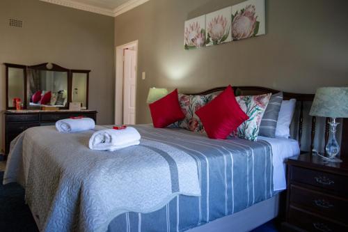 a bedroom with a bed with towels on it at Ailani Blue Room in Benoni