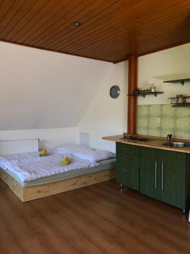 a bedroom with a bed and a sink in it at Apartmán LUČA in Liptovský Mikuláš