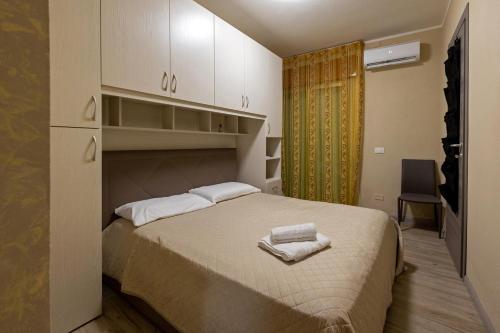 a bedroom with a bed with two towels on it at Stella room & apartment in Marsala