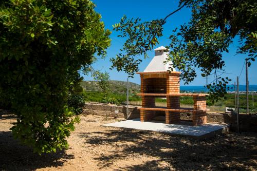 a brick bird house with a white roof at La Casa del Monte in Les Cases d'Alcanar
