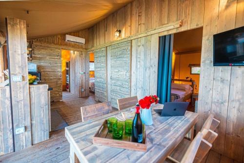 a wooden room with a table with a laptop on it at Camping Village Riva Blu in Padenghe sul Garda