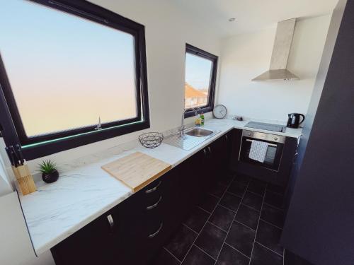 a kitchen with a counter and a sink and a window at 2 Bed New Build Apartment - Sleeps 6 - Close to City Centre - Free Parking in Elswick