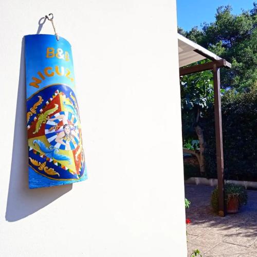 a blue towel hanging on a white wall at Nicuzza in Martano