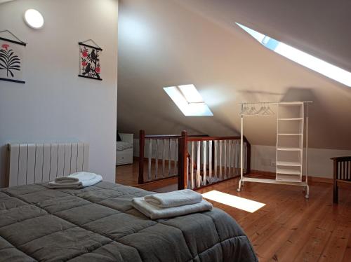a bedroom with a bed and a staircase with skylights at Fantástico apartamento en las playas de Suances in Suances