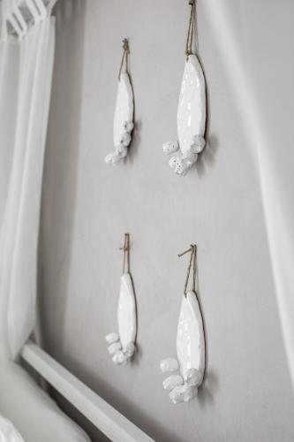 a group of mirrors hanging on a wall at Giardino Dei Pini - Boutique Hotel in Alliste
