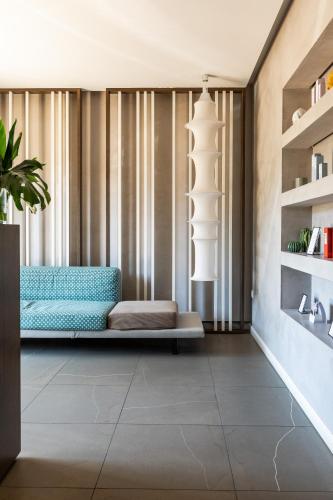 a living room with a couch in front of a window at Giardino Dei Pini - Boutique Hotel in Alliste
