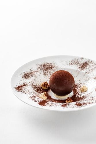 a chocolate dessert on a plate on a white table at Giardino Dei Pini - Boutique Hotel in Alliste