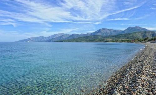 a large body of water with mountains in the background at Le Panoramic in Saint-Florent