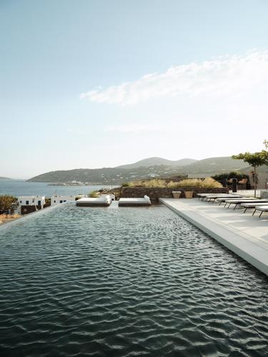 a pool of water with a view of the ocean at NOS Hotel & Villas in Sifnos