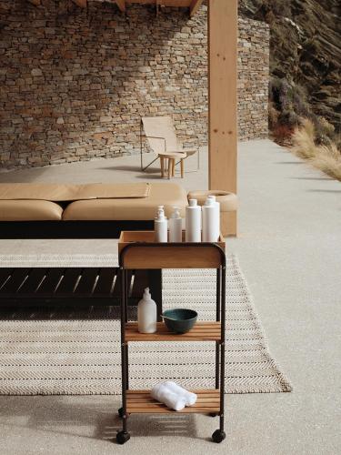 a cart with white vases on it on a patio at NOS Hotel & Villas in Sifnos
