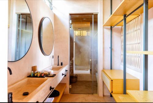 a bathroom with a sink and a mirror and a shower at Birdcage 33 Hotel - Adult Only in Yalıkavak