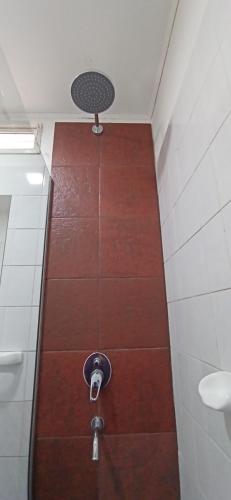 a small bathroom with a shower with a fan at Cabañas Nubes del Plata in Potrerillos