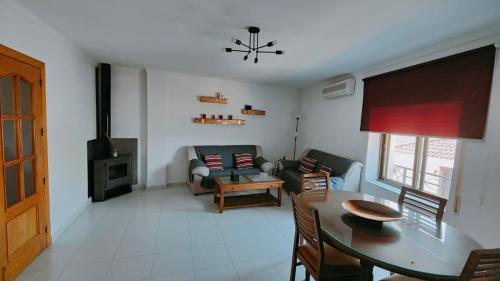 a living room with a couch and a table and a fireplace at Alojamiento Rural El Peñon de Hornos in Hornos