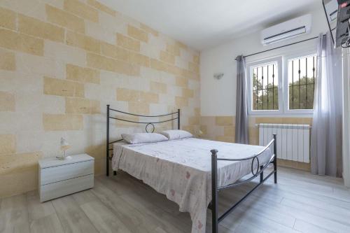 a bedroom with a bed and a window at Villa La Fenice by BarbarHouse in San Pietro in Bevagna