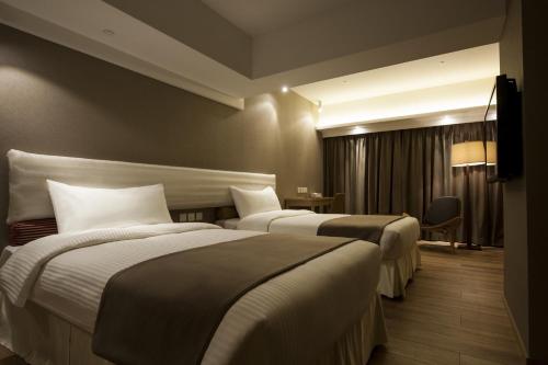 Postel nebo postele na pokoji v ubytování Inn Hotel Macau
