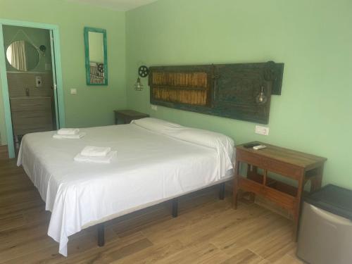 a bedroom with a bed with two towels on it at Habitaciones Sajorami Beach in Zahora